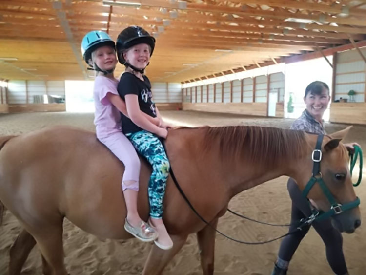 Children riding a pony in the state of the art indoor arena